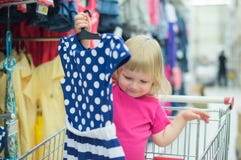 Adorable Baby On Cart Choose Clothes Royalty Free Stock Photo