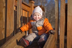 Adorable Baby Sliding From Baby Slide In Park Stock Photos