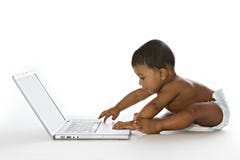 Adorable baby working on laptop