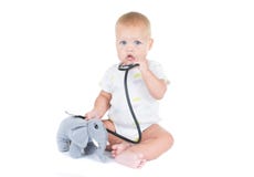 Adorable child dressed as doctor playing with toy Isolated on white background stock photography Adorable child dressed as doctor playing with toy Isolated on white background stock photography