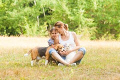 Adorable couple daughter and mom sitting on a grass with their pets royalty free stock images Adorable couple daughter and mom sitting on a grass with their pets royalty free stock images