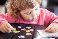 Adorable happy little child playing with puzzle. stock images Adorable happy little child playing with puzzle. stock images