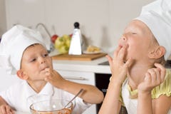 Adorable Kids In White Apron Tasting Food Royalty Free Stock Photo