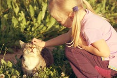 Adorable Little Caucasian Girl Stroking Her Cat. Royalty Free Stock Photo Adorable Little Caucasian Girl Stroking Her Cat. Royalty Free Stock Photo