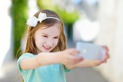 Adorable Little Girl Taking A Photo Of Herself Stock Images