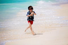 Adorable preschool children, boys, having fun on ocean beach. Excited children playing with waves, swimming, splashing happily stock image Adorable preschool children, boys, having fun on ocean beach. Excited children playing with waves, swimming, splashing happily stock image