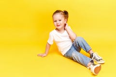 Adorable stylish girl posing on yellow background royalty free stock photography Adorable stylish girl posing on yellow background royalty free stock photography
