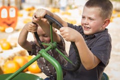 Adorable Young Boys Playing on an Old Tractor Outside royalty free stock photography Adorable Young Boys Playing on an Old Tractor Outside royalty free stock photography
