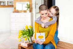 Adorable young girl and her mom, young cancer patient, reading a homemade greeting card. Family concept. Happy Mother`s Day. royalty free stock photo Adorable young girl and her mom, young cancer patient, reading a homemade greeting card. Family concept. Happy Mother`s Day. royalty free stock photo