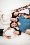 Adult happy couple with cute little son and daughter lies on bed in mattress store. royalty free stock photos Adult happy couple with cute little son and daughter lies on bed in mattress store. royalty free stock photos