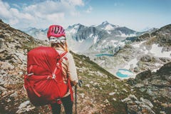 Adventurer tourist hiking in mountains with backpack Travel Lifestyle hiking adventure concept summer vacations outdoor exploring
