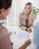 Adviser, broker and customers sitting at desk in the office. royalty free stock image Adviser, broker and customers sitting at desk in the office. royalty free stock image