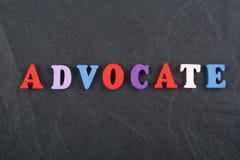 ADVOCATE word on black board background composed from colorful abc alphabet block wooden letters, copy space for ad text stock image ADVOCATE word on black board background composed from colorful abc alphabet block wooden letters, copy space for ad text stock image