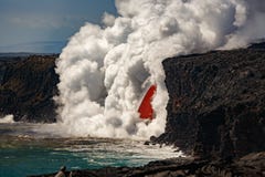 Aerial daytime view of fire hose waterfall shaped flow of red lava from volcano in Hawaii exploding into the turquoise sea stock photo Aerial daytime view of fire hose waterfall shaped flow of red lava from volcano in Hawaii exploding into the turquoise sea stock photo