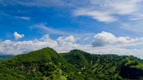 Aerial landscape view of green mountains and blue sky. With clouds at village Candidasa, Bali, Indonesia Stock Photography Aerial landscape view of green mountains and blue sky. With clouds at village Candidasa, Bali, Indonesia Stock Photography
