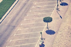 Aerial picture of an empty parking lot. Vintage toned aerial picture of an empty parking lot with trees and pavement Royalty Free Stock Photos Aerial picture of an empty parking lot. Vintage toned aerial picture of an empty parking lot with trees and pavement Royalty Free Stock Photos