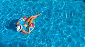 Aerial top view of beautiful girl in swimming pool from above, relax swim on inflatable ring donut in water on family stock photography Aerial top view of beautiful girl in swimming pool from above, relax swim on inflatable ring donut in water on family stock photography