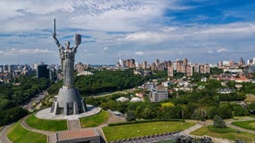 Aerial Top View Of Kiev Motherland Statue Monument On Hills From Above And Cityscape, Kyiv, Ukraine Stock Photos