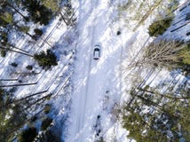 Aerial view of a car on winter road. Winter landscape countryside. Aerial photography of snowy forest with a car on the road. Stock Image Aerial view of a car on winter road. Winter landscape countryside. Aerial photography of snowy forest with a car on the road. Stock Image