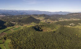 Aerial view of Garrotxa Volcanic Zone Natural Park and Santa Margarida Volcano in the foreground Royalty Free Stock Images Aerial view of Garrotxa Volcanic Zone Natural Park and Santa Margarida Volcano in the foreground Royalty Free Stock Images
