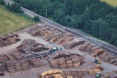Aerial view of stacked lumber piles with heavy moving machinery and a railway track. stock photography Aerial view of stacked lumber piles with heavy moving machinery and a railway track. stock photography