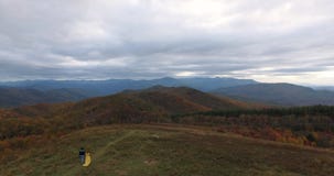 Aerial view Sunset on Max Patch MountainAppalachian Mountains, Tennessee & North Carolina, young woman in yellow dress stock video Aerial view Sunset on Max Patch MountainAppalachian Mountains, Tennessee & North Carolina, young woman in yellow dress stock video