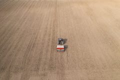 Aerial view of tractor doing farming and sowing wheat