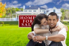 Affectionate Hispanic Couple, New Home and For Sale Real Estate Sign stock photo Affectionate Hispanic Couple, New Home and For Sale Real Estate Sign stock photo