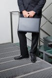 Affärsman With Briefcase Standing vid moment royaltyfria foton Affärsman With Briefcase Standing vid moment royaltyfria foton