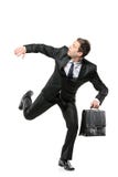 An afraid businessman running away