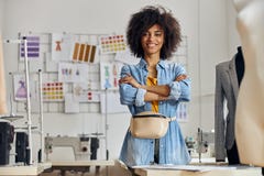 African-American Entrepreneur With Crossed Hands Poses For Camera In Sewing Workshop Royalty Free Stock Photography