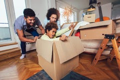 African American family, parents and daughter, unpacking boxes and moving into a new home stock images African American family, parents and daughter, unpacking boxes and moving into a new home stock images