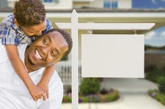 African American Father and Mixed Race Son In Front of Blank Real Estate Sign and House royalty free stock photography African American Father and Mixed Race Son In Front of Blank Real Estate Sign and House royalty free stock photography