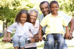 African American Grandparents With Grandchildren Cycling In Park stock images African American Grandparents With Grandchildren Cycling In Park stock images