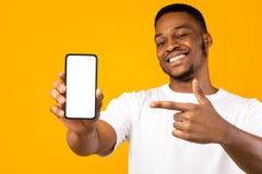 African American Man Showing Mobile Phone Screen, Yellow Background, Mockup Stock Image