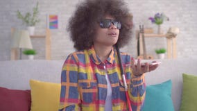 African american woman with an afro hairstyle visually impaired uses voice assistant on your smartphone close up stock video footage African american woman with an afro hairstyle visually impaired uses voice assistant on your smartphone close up stock video footage
