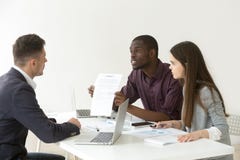 African American worker blaming Caucasian partner for document m royalty free stock photography African American worker blaming Caucasian partner for document m royalty free stock photography
