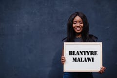 African woman hold white board with Blantyre Malawi inscription. Most populous city in Africa concept