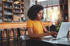 Young woman tying on laptop in cafe royalty free stock images Young woman tying on laptop in cafe royalty free stock images