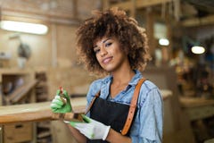 Young woman doing woodwork in a workshop Royalty Free Stock Images Young woman doing woodwork in a workshop Royalty Free Stock Images