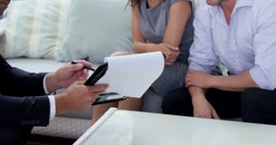 Agent showing contract to couple