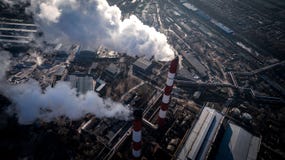 Air pollution by smoke coming out of two factory chimneys. Aerial view Royalty Free Stock Images Air pollution by smoke coming out of two factory chimneys. Aerial view Royalty Free Stock Images