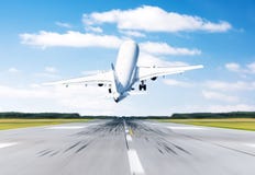 Airplane flying departure take off on a runway airport good weather with a blue sky clouds on a runway. Back view. Royalty Free Stock Photo Airplane flying departure take off on a runway airport good weather with a blue sky clouds on a runway. Back view. Royalty Free Stock Photo