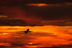 Airplane landing or takeoff in the sunset with red sky in Bucharest international airport , Plain spotting royalty free stock photo Airplane landing or takeoff in the sunset with red sky in Bucharest international airport , Plain spotting royalty free stock photo