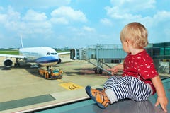 In airport hall child looks at the plane through window royalty free stock images In airport hall child looks at the plane through window royalty free stock images