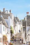 Alberobello, Apulia - JUNE 1, 2017 - Tourists walking through a stock images Alberobello, Apulia - JUNE 1, 2017 - Tourists walking through a stock images