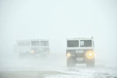 The all-terrain vehicle for snow trips to a snow blizzard in the tundra. Special car for the Arctic safari. stock image The all-terrain vehicle for snow trips to a snow blizzard in the tundra. Special car for the Arctic safari. stock image