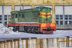 Allein sowjetischer alter Zug im Winter vor dem hintergrund der Bahndepothangars und -schienen stockbild Allein sowjetischer alter Zug im Winter vor dem hintergrund der Bahndepothangars und -schienen stockbild