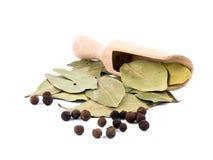 Allspice berries with wooden shovel and laurel stock photos Allspice berries with wooden shovel and laurel stock photos