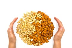 Almond and cashew nut with woman hands on white background. Nut ornament in palms. Tasty healthy snack stock images Almond and cashew nut with woman hands on white background. Nut ornament in palms. Tasty healthy snack stock images